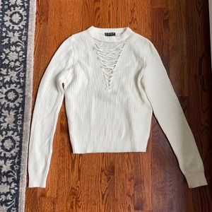 White sweater with string cross neck